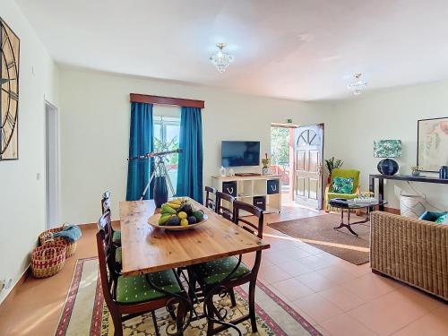 a living room with a table with a bowl of fruit on it at Alojamento Funchal - Silvestre House in Funchal