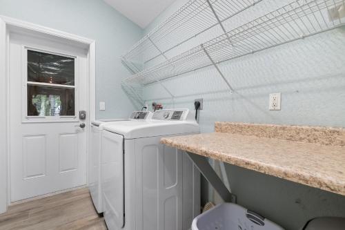A kitchen or kitchenette at Nautical Escape! Private pool home with a tropical backyard oasis!