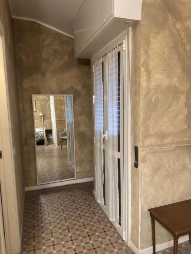 a hallway with a door and a mirror and a table at Villa Giovanna Citylife Milano in Milan