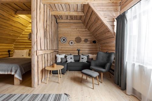 a bedroom with a bed and a couch and a chair at Gremi Hotel in Dragobrat