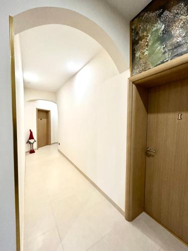 an empty hallway with a door and a painting on the wall at AD BASANTE in Bosanski Šamac