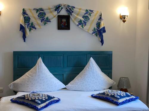 a bedroom with a bed with pillows on it at Casa Soarelui in Murighiol