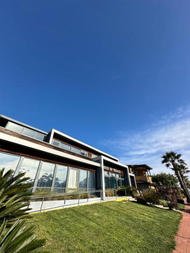 an exterior view of a building with glass windows at House of Trestles in San Clemente