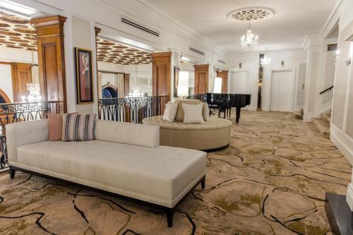 a living room with a couch and a table at The Lord Nelson Hotel & Suites in Halifax