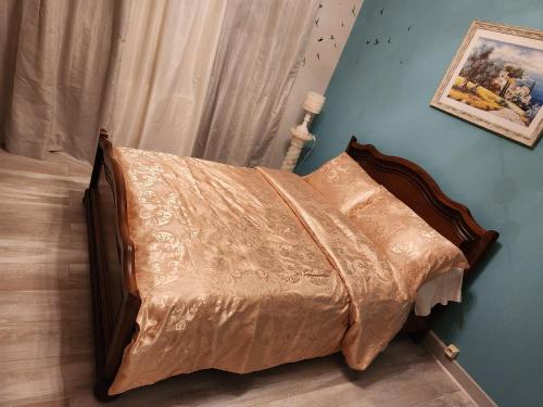 - un lit avec une couette brune dans une chambre dans l'établissement Maison de vacances, à Saint-Amour