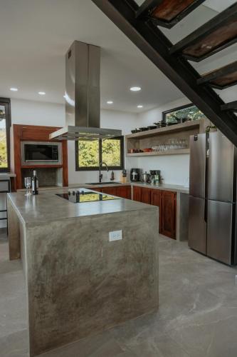 a kitchen with a large island in the middle at Vida Palace in Jacó