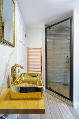 a bathroom with a yellow sink and a shower at The Famous Harry Potter House, Hot Tub, Cinema Room, Sky TV in Saffron Walden