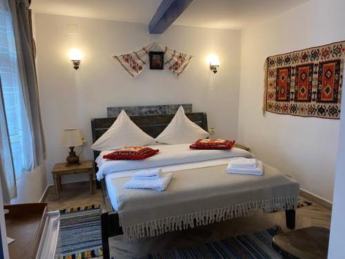 a bedroom with a bed with two pillows on it at Casa Soarelui in Murighiol