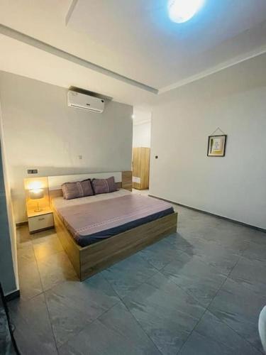 a bedroom with a large bed in a room at Serenity Haven:Your Ideal Escape in Lomé