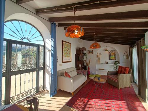 un soggiorno con una grande finestra e un divano di Private House in the Heart of Nature, Sea View a Moclinejo