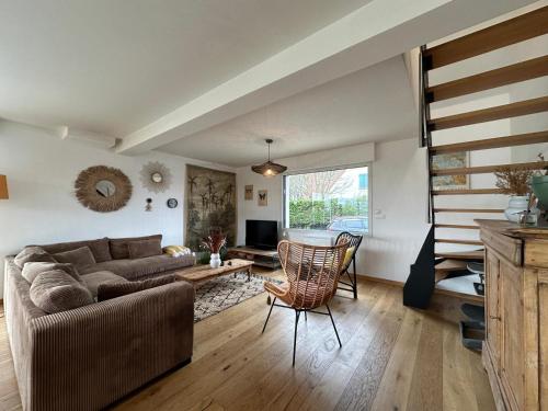a living room with a couch and a table at Villa Marius proche de la plage in Ambleteuse