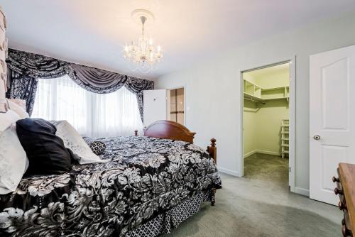 a bedroom with a bed and a chandelier at The Bruce Trail Retreat in St. Catharines