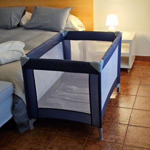a bed with a blue and white bed frame at Apartamento Parque Gredos in Arenas de San Pedro