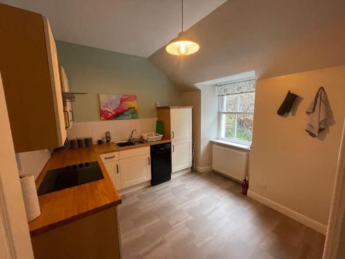 a kitchen with a sink and a counter top at Carronvale. 3 Bedroom Oban Apartment. in Oban