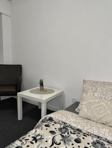 a bedroom with a bed and a table and a chair at Mitten in der Stadt in Liestal