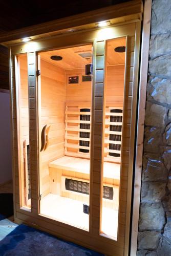 a sauna is shown with a stone wall at Vila Olimp in Jasenak