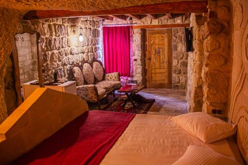 a bedroom with a large bed in a stone room at Junior Ottoman Cave in Ürgüp
