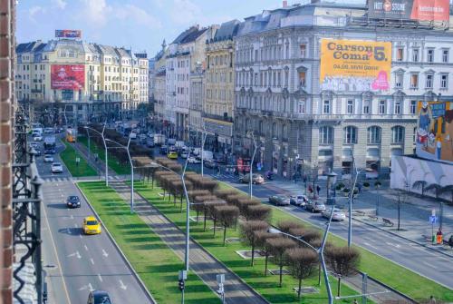 a busy city street with cars and buildings at Big Wheel Panoramica Apartment II. in Budapest