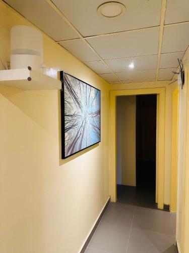 a hallway with a television on the wall at Sunrise Inn by Lavish Hub in Abu Dhabi