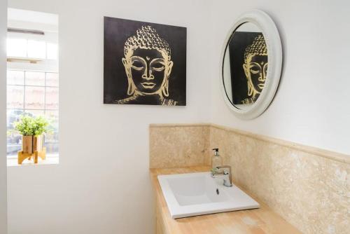 a bathroom with a sink and a mirror at Deluxe 1 Bed Versace Hot Tub Sky TV Cinema Screen in Great Sampford