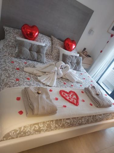 a bed with hearts on it with two red lights at SUITE 20m2 DANS VILLA PISCINE JACUZZI in Gattières