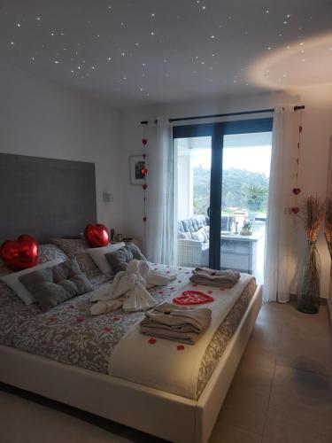 a bedroom with a large bed and a large window at SUITE 20m2 DANS VILLA PISCINE JACUZZI in Gattières