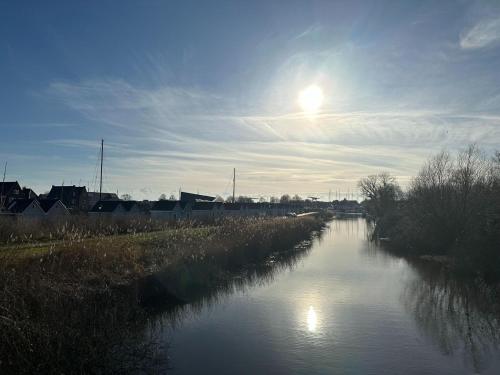 a view of a river with the sun in the sky at Holiday Home in Stavoren by Private Jetty in Stavoren