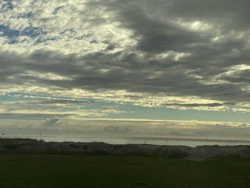 a cloudy sky over a body of water at Holiday Home in Stavoren by Private Jetty in Stavoren
