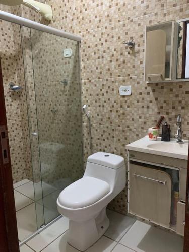 a bathroom with a shower and a toilet and a sink at Casa no francês! in Marechal Deodoro