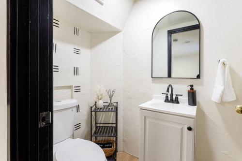 a white bathroom with a sink and a mirror at Pet Friendly Treetop Cabin w/Deck & Forest Views in Twin Peaks