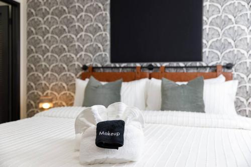 a hotel room with a bed with a maccapa towel at Pet Friendly Treetop Cabin w/Deck & Forest Views in Twin Peaks
