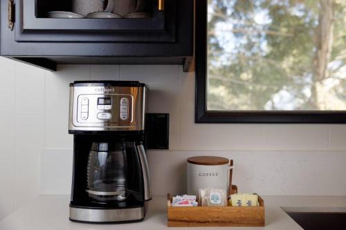 a coffeemaker sitting on a counter in a kitchen at Pet Friendly Treetop Cabin w/Deck & Forest Views in Twin Peaks