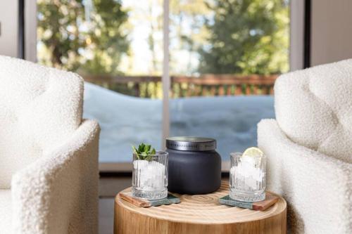 a table with a candle and two glasses on it at Pet Friendly Treetop Cabin w/Deck & Forest Views in Twin Peaks