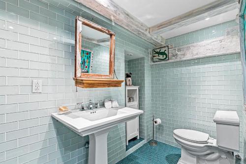 a blue bathroom with a sink and a toilet at Summer Rental Magical Converted Barn & Pool House in Pleasant Valley