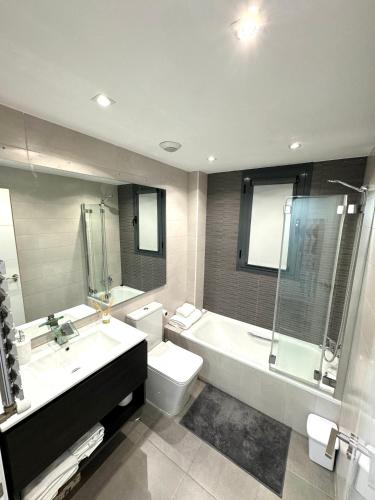 a bathroom with a sink and a toilet and a shower at APARTAMENTO LUXURY in Madrid
