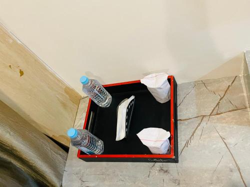 a box with two bottles of water on the floor at Royal Suites in Lucknow