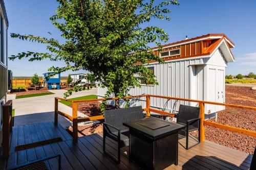 a deck with chairs and a table and a building at Una Vita in Apple Valley