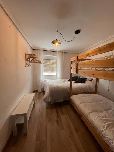 a bedroom with two bunk beds and a window at Casa Sina in Riópar