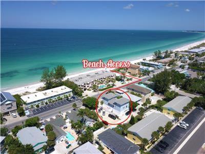 an aerial view of a beach resort with the ocean at Sea Site Retreat Unit B! Great attractions nearby! Short walk to the beach! in Bradenton Beach