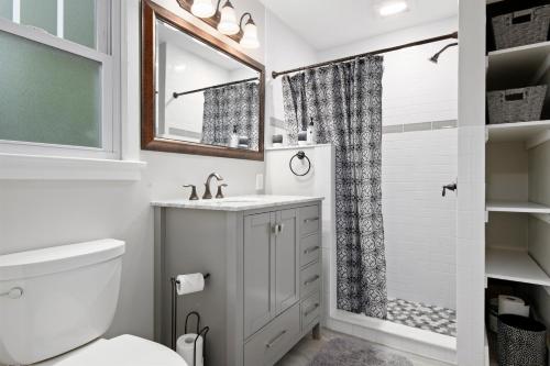 a white bathroom with a sink and a shower at Ville Villekulla! Private pool home near Historic Palmetto! in Palmetto