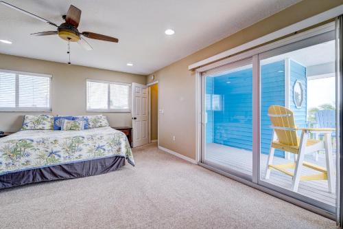 a bedroom with a bed and a large window at Sea Site Retreat Unit B! Great attractions nearby! Short walk to the beach! in Bradenton Beach