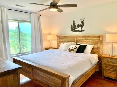 a bedroom with a large bed and a ceiling fan at Mountain Top Oasis in Sevierville