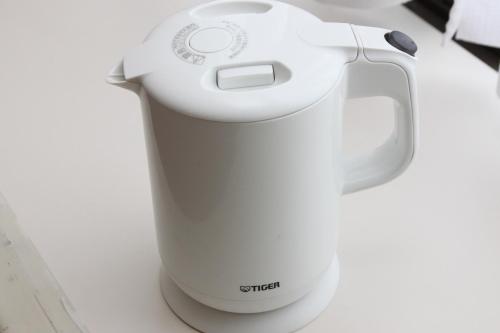 a white blender sitting on top of a counter at U-Community Hotel in Osaka