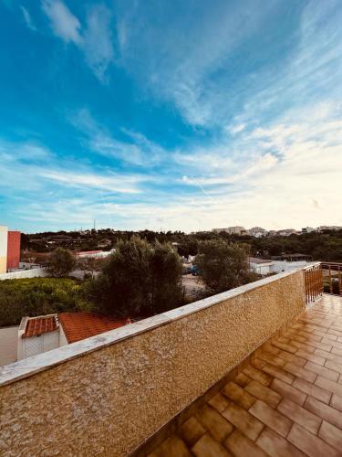 a balcony with a brick wall and a blue sky at Portimao Central Holiday Guesthouse in Portimão