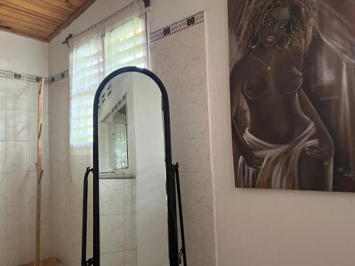 a bathroom with a mirror and a painting on the wall at Villa Melissa97- Bât2 Superbe coin à Dzamandzar in Ambondrona