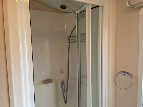 a shower with a glass door in a bathroom at BelLa VistA - Holiday Home On The Beach in Clacton-on-Sea