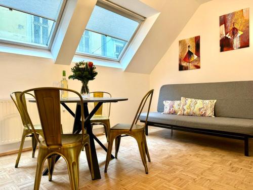 a living room with a table and chairs and a couch at ParkSide by BestChoice - Self Check-in with Parking Option in Graz