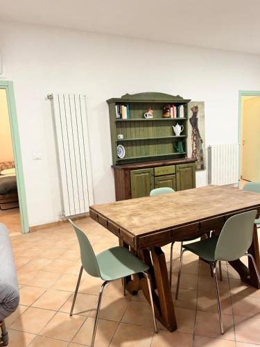 a dining room with a wooden table and chairs at Casa Rosa in Finale Ligure