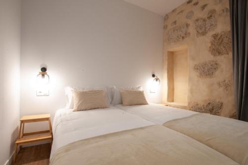 a bedroom with a large white bed with two pillows at La Casa de San Juan - BENTEJUI in Telde