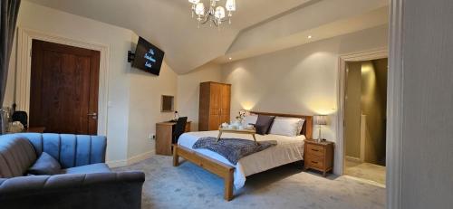 CastlereaにあるLisalway Country Lodgeのベッドルーム1室(ベッド1台、椅子、ソファ付)